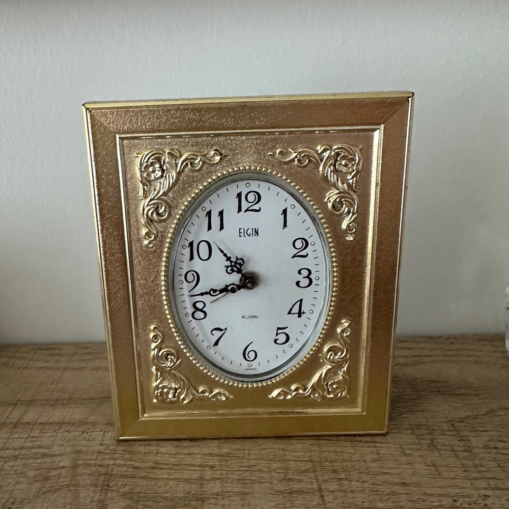 a vintage gold stand clock